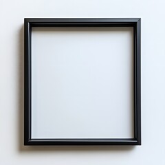 Elegant black picture frame against a bright white wall backdrop