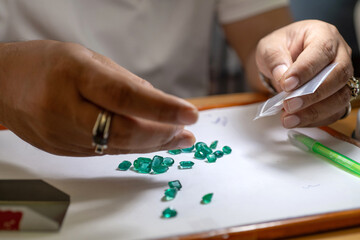 Close-up, gem dealer is examining gems that someone brought to sell, gem market in Chanthaburi,...