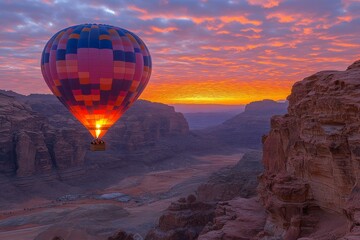 Obraz premium Hot air balloon glides through a stunning canyon at sunrise with vibrant skies and rocky cliffs in the background