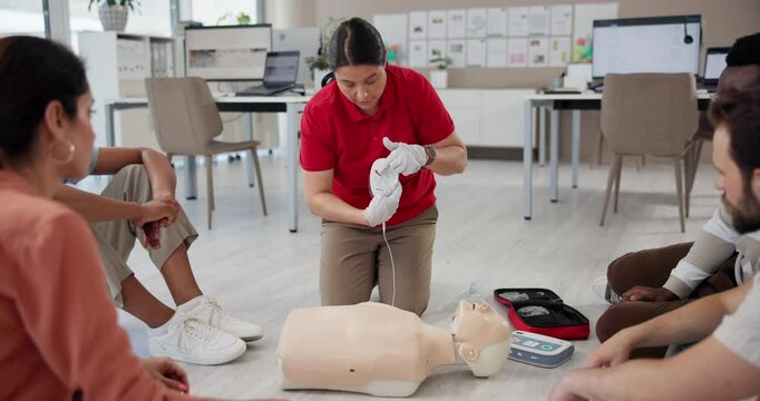 First aid training, people and AED demonstration for medical simulation, cardiac arrest help and emergency rescue. CPR mannequin, learning and instructor with health and safety technique at workplace