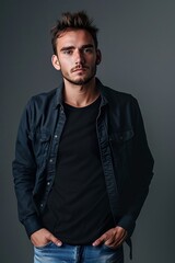 Fototapeta premium Confident young man in casual attire against gray background