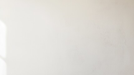 Minimalist interior wall with soft natural light casting shadows, creating a serene atmosphere