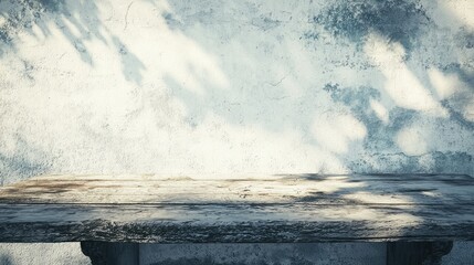 Weathered wooden table against a textured wall with soft shadows, ideal for rustic decor themes