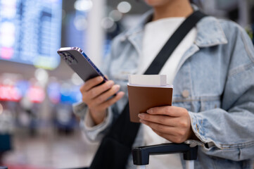 A close-up of a female passenger standing in the airport terminal, ready to travel.