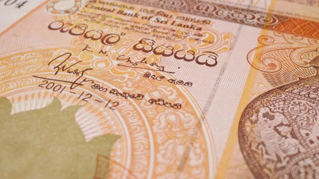 Old Sri Lankan 100-rupee banknote, close-up with a sliding motion.
