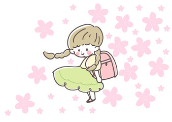 ピンクのランドセルを背負い、笑顔でこちらを見るおさげの女の子　入学式　桜　4月　春
