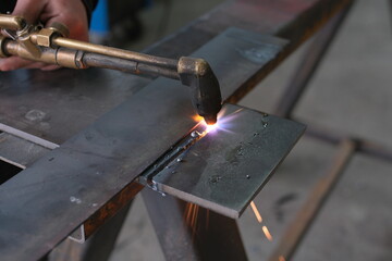 Industrial Metalworking Process: Precision Cutting, Welding, and Grinding Operations in a Manufacturing Facility