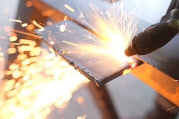 Industrial Metalworking Process: Precision Cutting, Welding, and Grinding Operations in a Manufacturing Facility