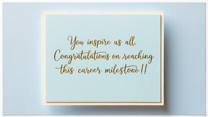 greeting card for career achievement, promotion or new job with a blue background and a golden font displaying the message You inspire us all. congratulations on reaching this career milestone.