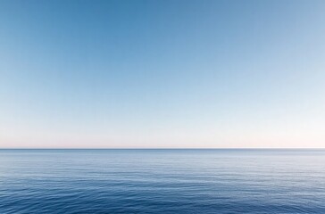 Serene Ocean Waves Gently Lapping Against a Tranquil Horizon Under a Soft Blue Sky
