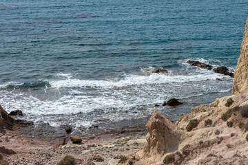 waves caressing the volcanic beach stones