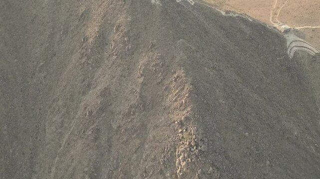 4k cinematic drone video of Khorfakkan mountains and Rabi tower showing the hiking trails and surrounding mountains and city of Khorfakkan