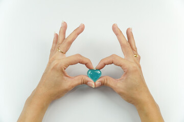Hands Forming Heart Shape with Blue Gemstone