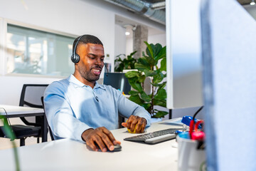 Smiling operator working with headset in coworking office