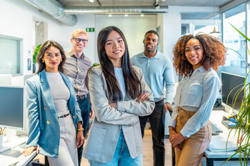 Confident business team smiling in modern coworking office