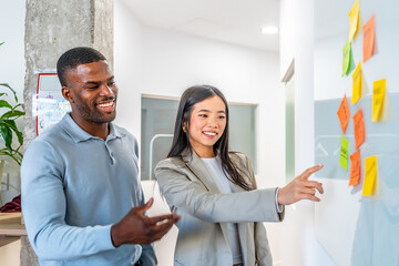 Managers discussing strategy using sticky notes in coworking office