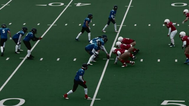 Diverse Group of Male Athletes Competing in an Intense American Football Championship on a Field, Showing Teamwork and Strategy. Players in Red and Blue Jerseys Engage in Dynamic Plays and Formations