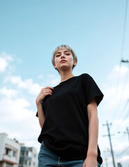 Fototapeta premium T-shirt mockup model outdoor, black plain t-shirt, female model in urban background