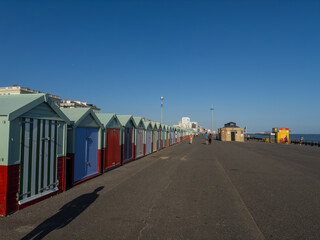 Obraz premium Seafront with colourful beach huts in Brighton, East Sussex, England.