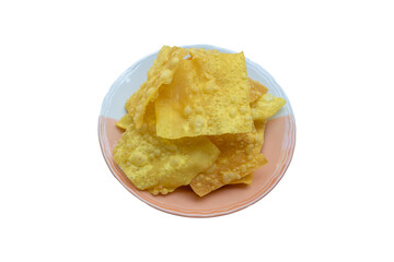Crispy fried dumpling sheets in a plate on isolated white background.