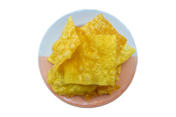 Crispy fried dumpling sheets in a plate on isolated white background.