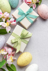 Easter gifts and speckled eggs with spring flowers