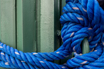Close Up of Textured Blue Rope Tied to Steel Plate Constructions.