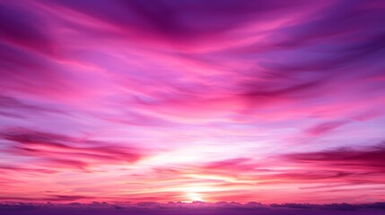 Vibrant sunset with pink and purple hues in sky.