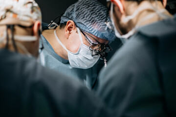 A team of professional surgeons performs surgery in a modern hospital. Concept skills working using...