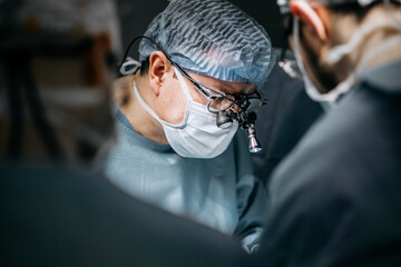 A team of professional surgeons performs surgery in a modern hospital. Concept skills working using the latest technology in cardiology and transplantation.