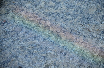Obraz premium Close-up of textured granite stone surface with natural color variations and patterns 