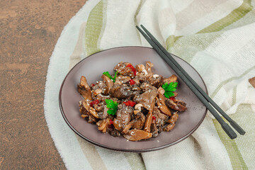 Delicious Shimeji mushrooms with chili pepper, sesame seeds and greens. Healthy Umami vegan food