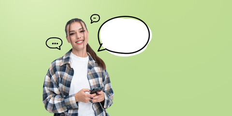 Woman holding phone with speech bubble icons on green background