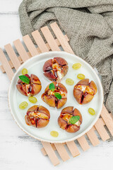 Oven-baked figs with camembert or brie cheese, herbs and honey. Healthy food, seasonal fruits