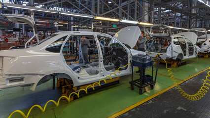 Close view of a car body on an assembly line.