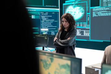 Cyber security expert in a national safety operations center detecting cyber attacks or threats. Governmental hacking team focusing on data protection, cyber operations in progress.