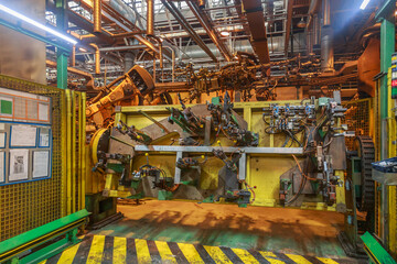 Passenger car parts ready for assembly on a conveyor line.