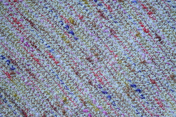 tweed beige  fabric as a macro background, suit polyurethane melange multicolored, knitwear wool stitch blue as a background 