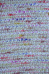tweed beige  fabric as a macro background, suit polyurethane melange multicolored, knitwear wool stitch blue as a background 