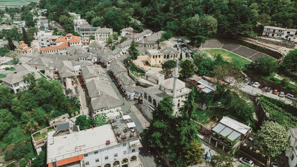 Obraz premium Aerial drone view of old quarters of Gjirokaster, Albania. Traditional houses in the old city of Gjirokaster. UNESCO World Heritage Site.