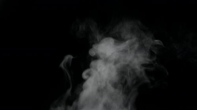 White natural rising steam from food or hot drink isolated on a black background. Сan be used in any projects with hot food. Slow motion.