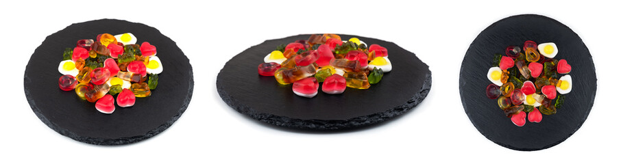 Assorted colorful gummy candies. Jelly sweets on stone plate