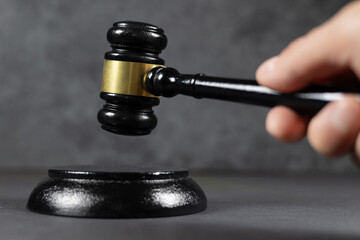 Judge hitting Gavel off a block in courtroom, law and Justice concept