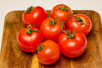 fresh tomatoes on a wooden chopping board