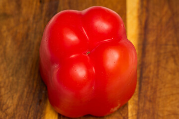 Red bell pepper on wooden table