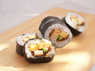Homemade sushi roll on wood board. Japanese food.