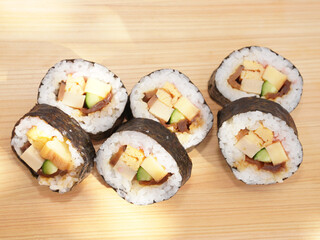 Homemade sushi roll on wood board. Japanese food.
