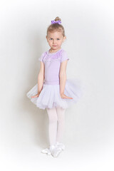 Cute little ballet dancer dancing posing for camera