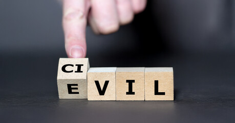 Hand turns cube and changes the word evil to civil.