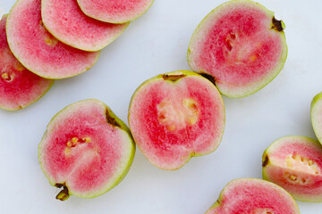 Fresh pink guava on white background.